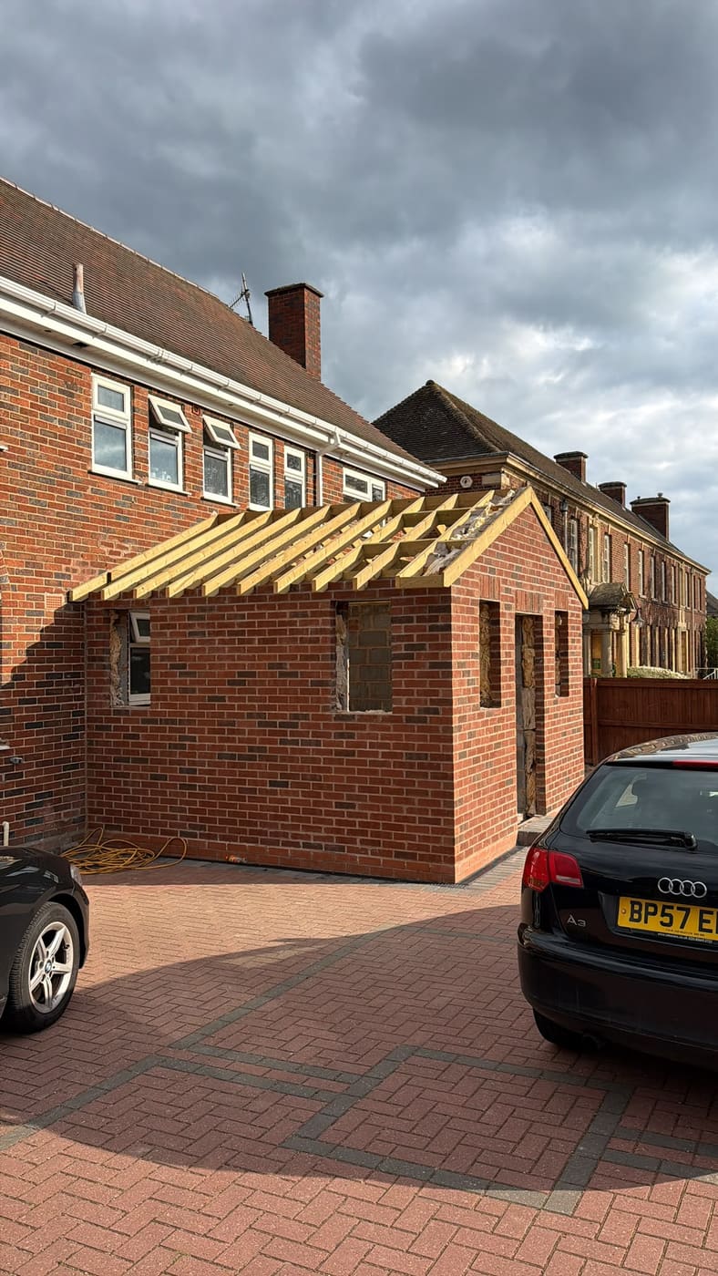 New brick outbuilding with the roof timbers up and ready for covering